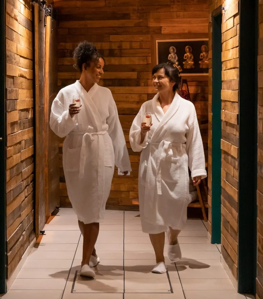 Two guests in robes walking through The Beauty Island Sanctuary