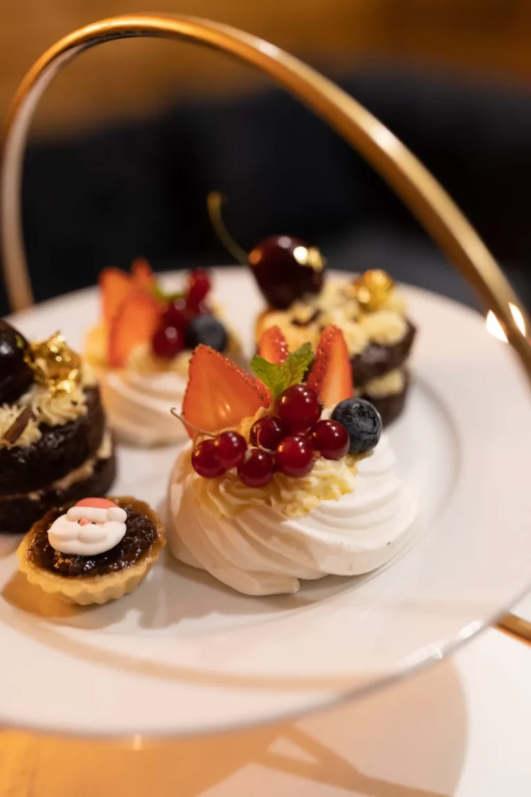 A selection of afternoon tea cakes topped with berries