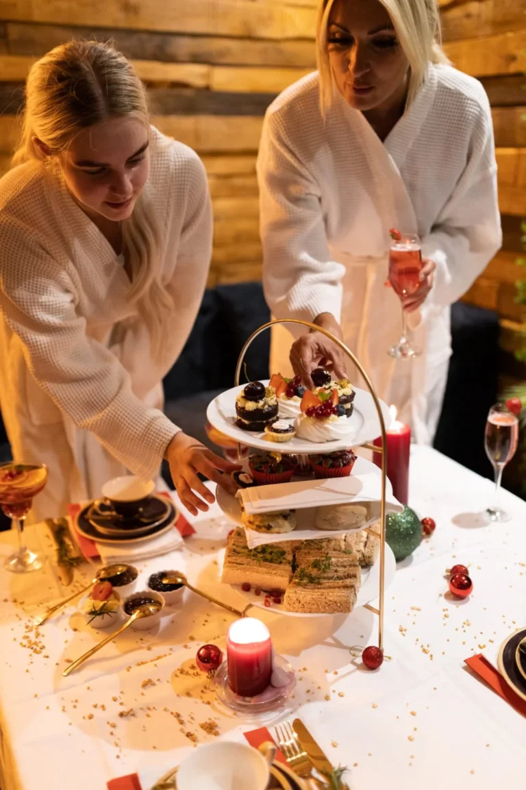 Two guests in spa robes sharing afternoon tea in the Balinese-inspired suite